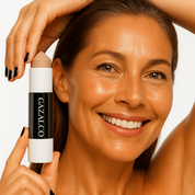 Woman holding a skincare product with 'Gazalo' branding against a neutral background